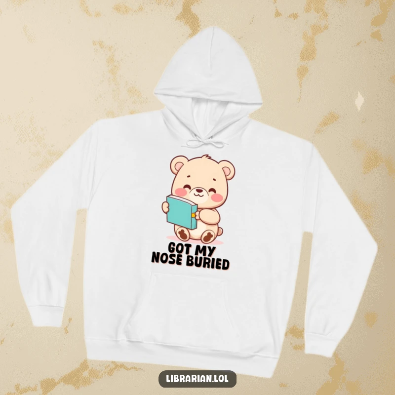 Funny Bear Cub hoodie illustration of a charming character extending a book with a happy grin, perfect for cozy reading sessions.