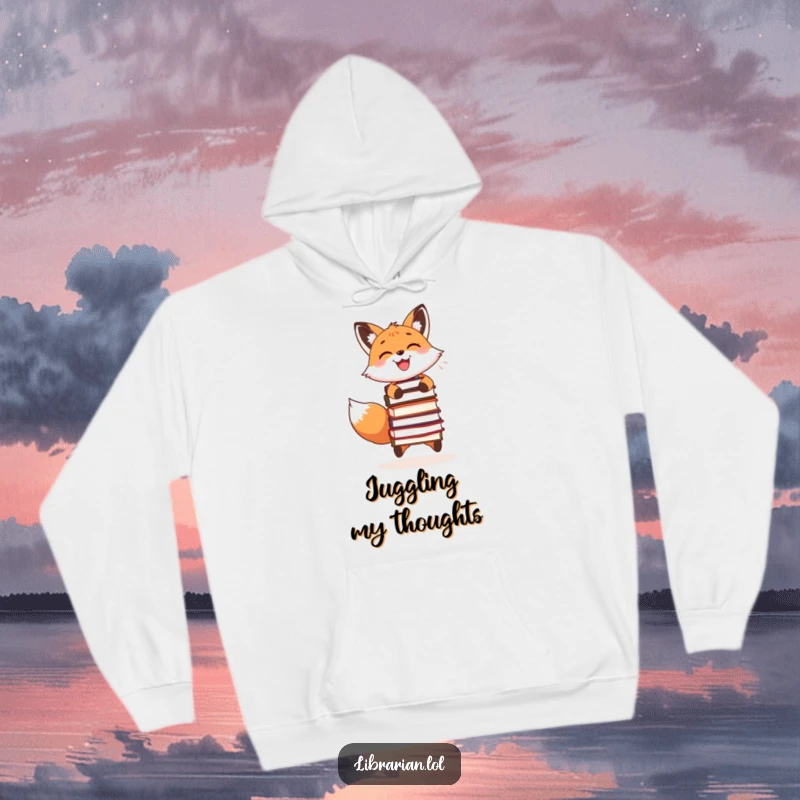 Funny hoodie featuring a joyful fox juggling books, ideal for cozy reading sessions and sharing a laugh.