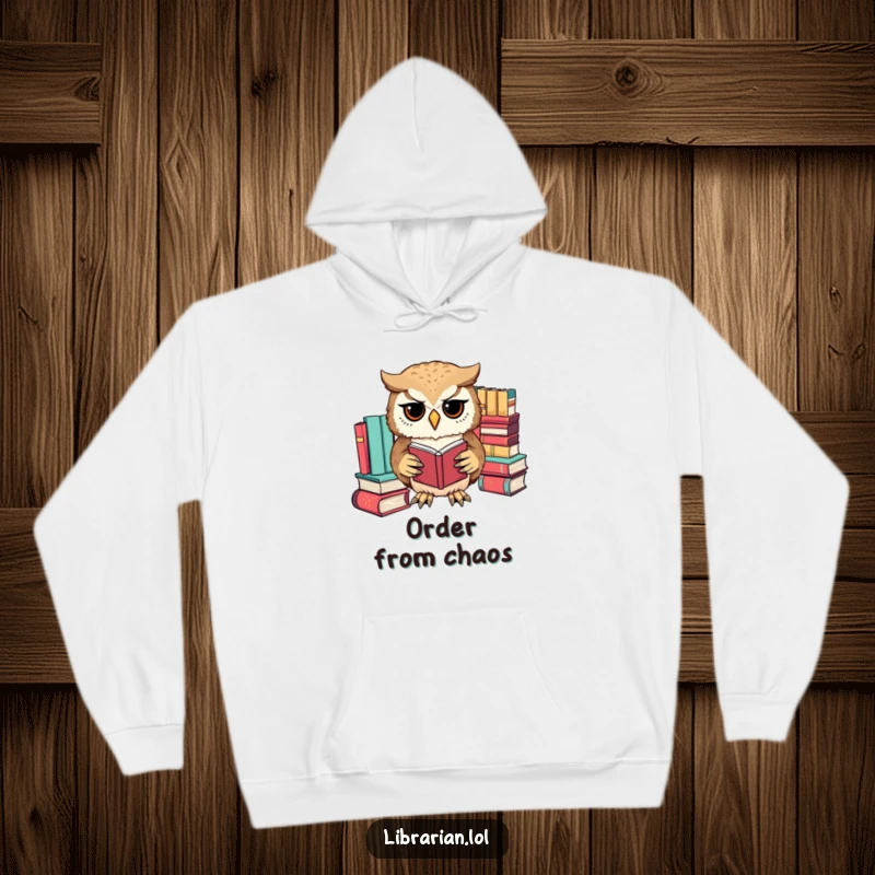 Funny owl meticulously sorting books by color with its tiny paws, a cozy hoodie for bibliophiles who love order.