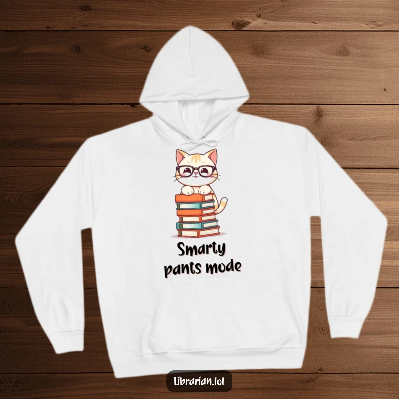 Funny hoodie featuring a smiling cat in glasses, meticulously stacking a precarious tower of books, perfect for cozy moments.